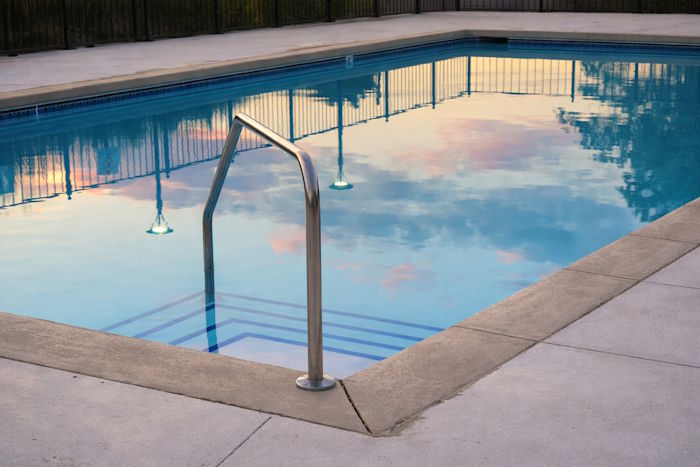 Clear pool reflecting colorful sky