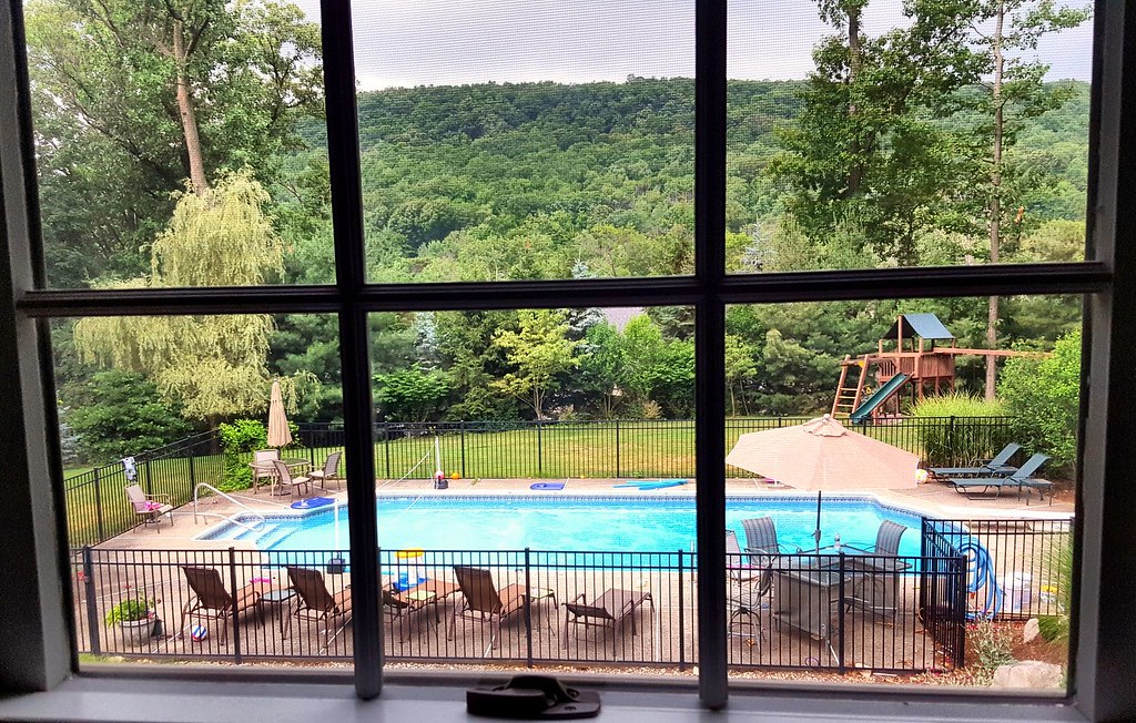 Professional pool opening service Winnipeg - clean blue backyard pool